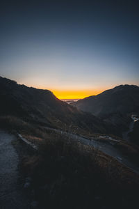 Scenic view of mountains against clear sky during sunset