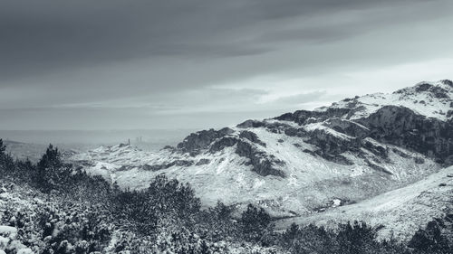 Scenic view of mountains against sky during winter