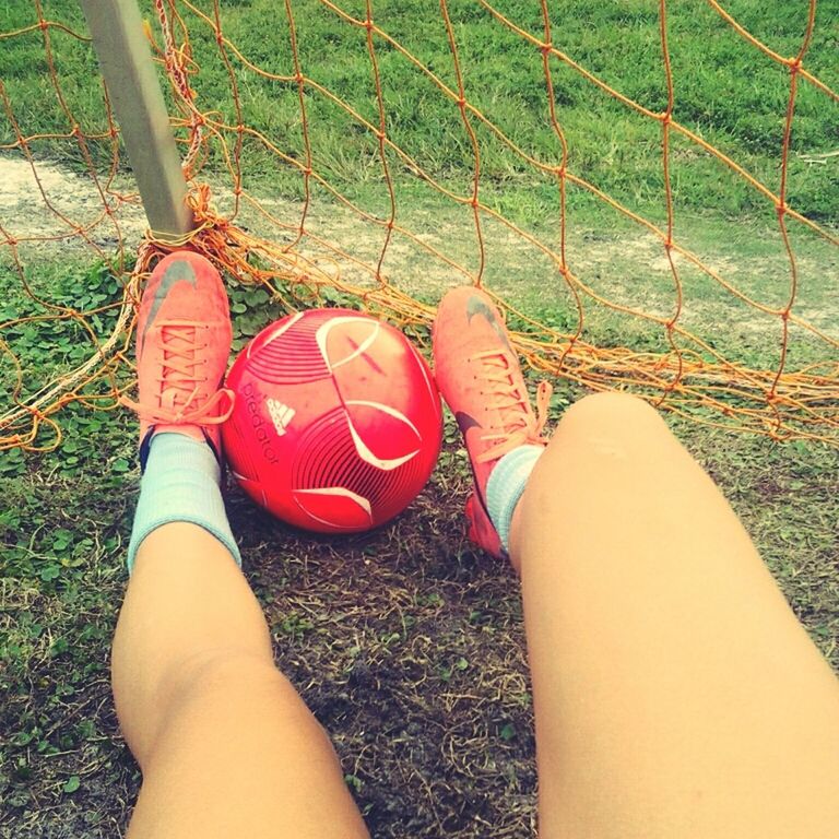 low section, person, personal perspective, shoe, grass, lifestyles, leisure activity, human foot, footwear, high angle view, field, red, standing, part of, relaxation, canvas shoe