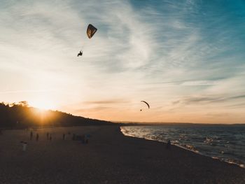 Scenic view of beach against sky during sunset