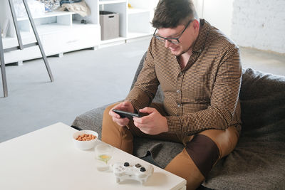 Side view of man using mobile phone