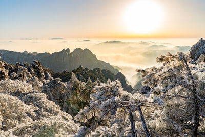 Scenic view of snowcapped mountains against sky during sunset