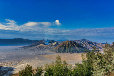 Scenic view of mountains against cloudy sky