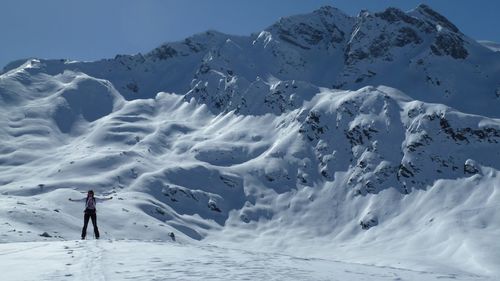 Full length of person standing on snowcapped mountain