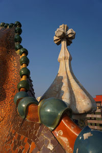 Low angle view of sculpture against clear blue sky