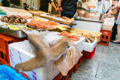 Midsection of man buying seafood at market