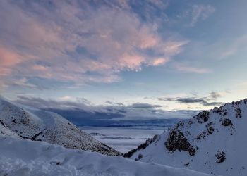 Scenic view of snow covered mountains against sky