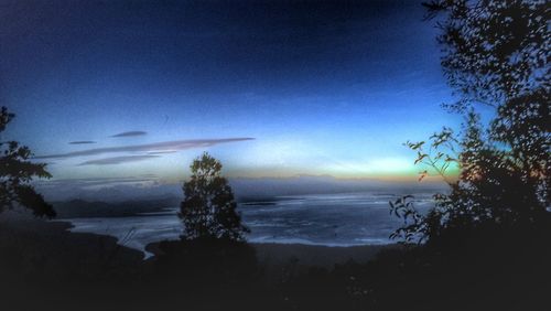 Scenic view of sea against sky at night