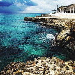 Scenic view of sea against cloudy sky