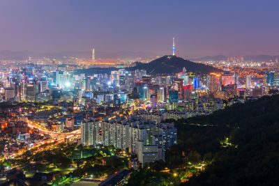 High angle view of illuminated buildings against sky at night