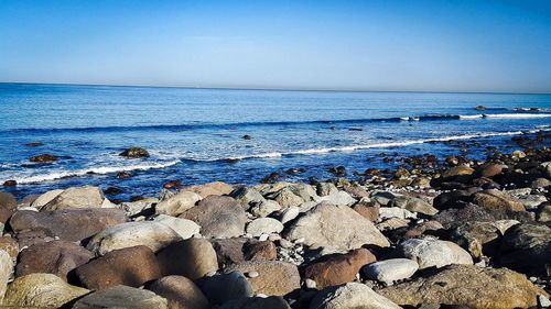 Scenic view of sea against clear blue sky