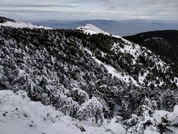 Scenic view of snow covered mountains against sky