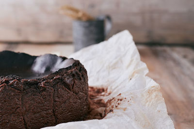 Chocolate basque cheesecake on a wooden table ready to serve