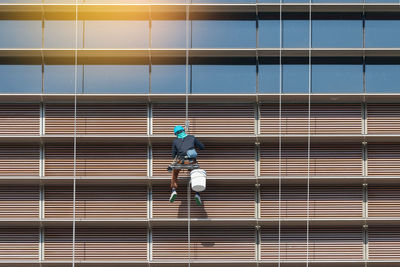 Man working against blue sky