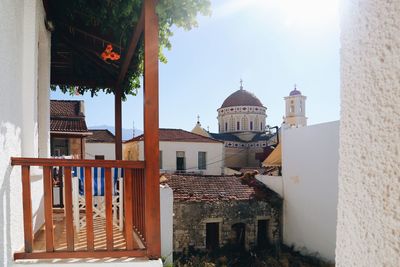 Buildings and church in mediterranean city against sky