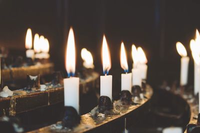 Close-up of lit candles in temple