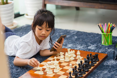 Full length of girl playing with toys at home