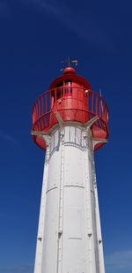 Low angle view of lighthouse against blue sky