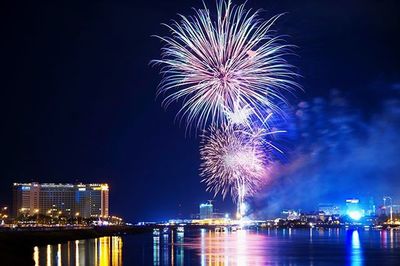 Firework display over river at night