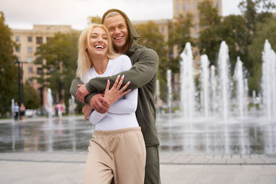 Happy young couple standing outdoors