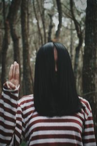 Rear view of woman in forest