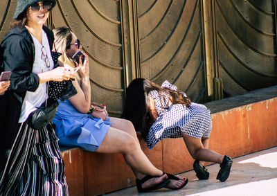 Woman sitting on the wall