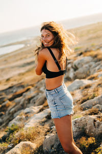 Full length of woman standing at beach