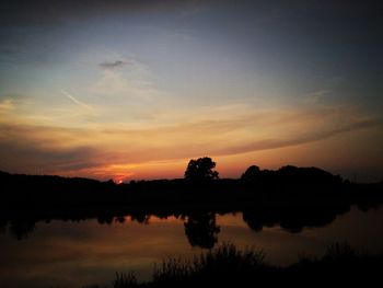 Scenic view of lake against sky during sunset