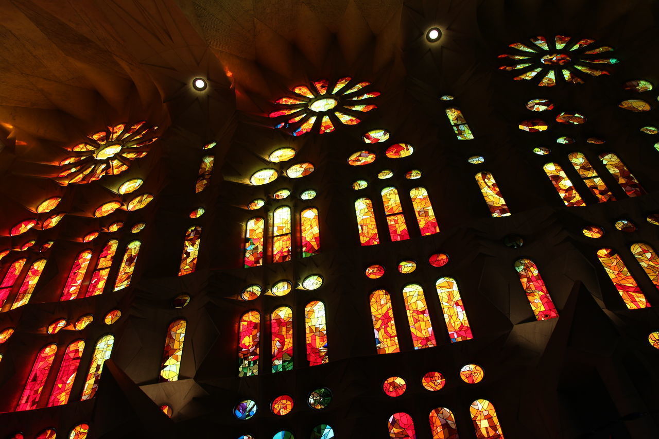 LOW ANGLE VIEW OF ILLUMINATED LIGHTS ON CEILING AT NIGHT