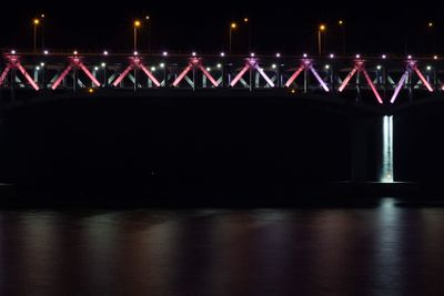 Illuminated bridge at night