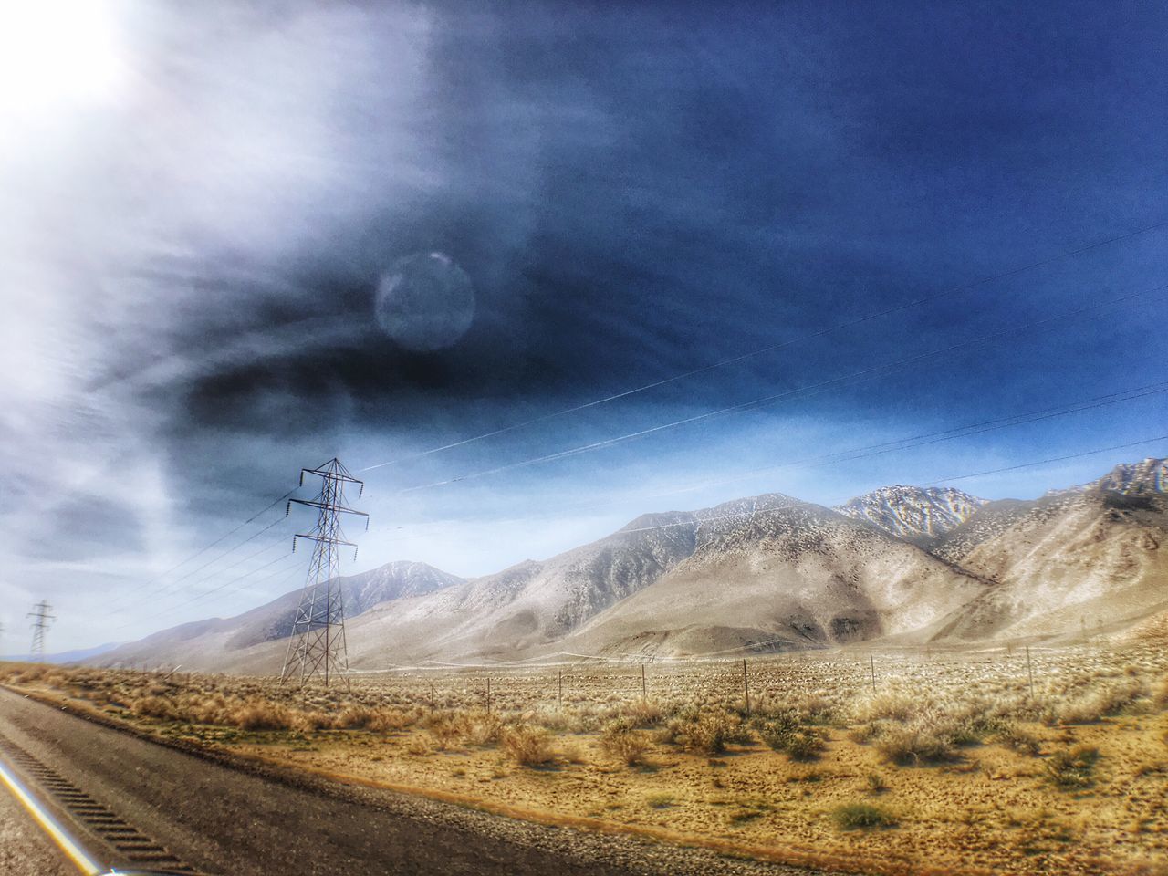 mountain, sky, landscape, mountain range, fuel and power generation, electricity pylon, cloud - sky, transportation, tranquility, tranquil scene, nature, power line, scenics, wind turbine, electricity, technology, alternative energy, beauty in nature, cloud, non-urban scene