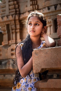 Portrait of young woman standing outdoors