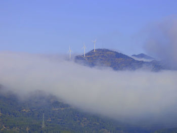 View of windmills on mountain against sky