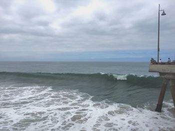 Scenic view of sea against cloudy sky