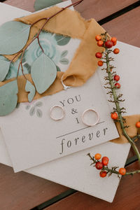 High angle view of wedding ring on table with envelope
