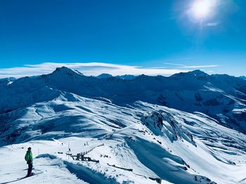 Scenic view of snowcapped mountain against blue sky