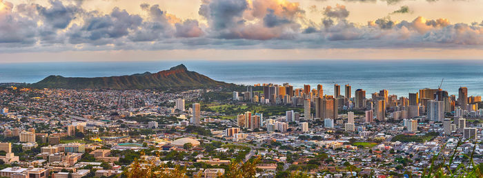 High angle view of buildings by sea against sky