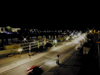 Blurred motion of man on illuminated street at night