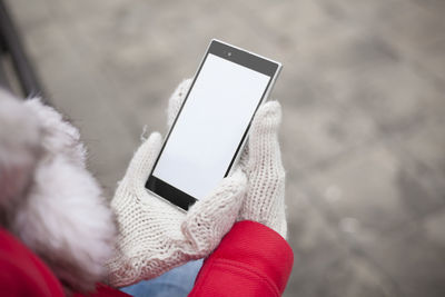 Close-up of person holding mobile phone in winter