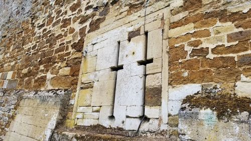 Low angle view of weathered wall on old building