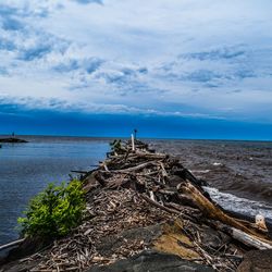 Scenic view of sea against cloudy sky