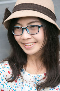 Close-up of smiling young woman wearing eyeglasses