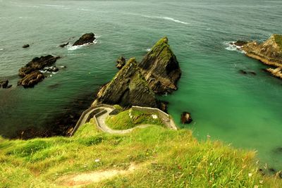 High angle view of rock formations by sea