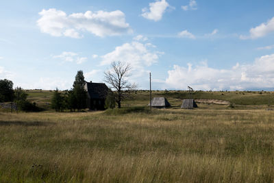 Scenic view of field against cloudy sky