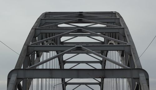 Low angle view of metal bridge against sky