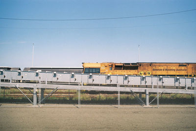 Train on railroad station against clear sky