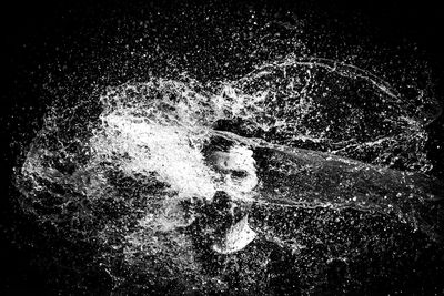 Close-up of splashing water against black background