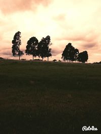 Scenic view of grassy field against cloudy sky