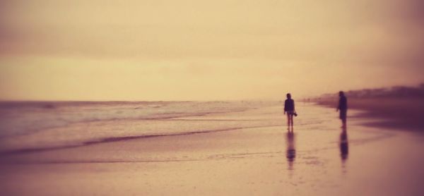 People on beach at sunset