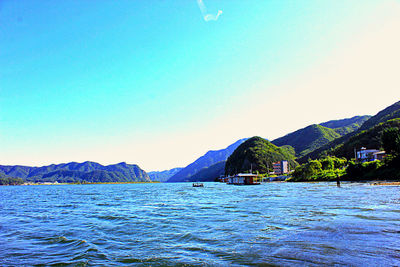 View of calm sea with mountain range in background